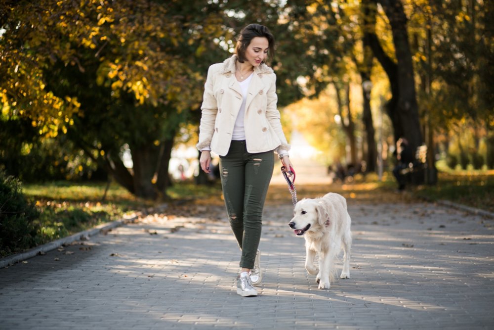 girl walking an old dog